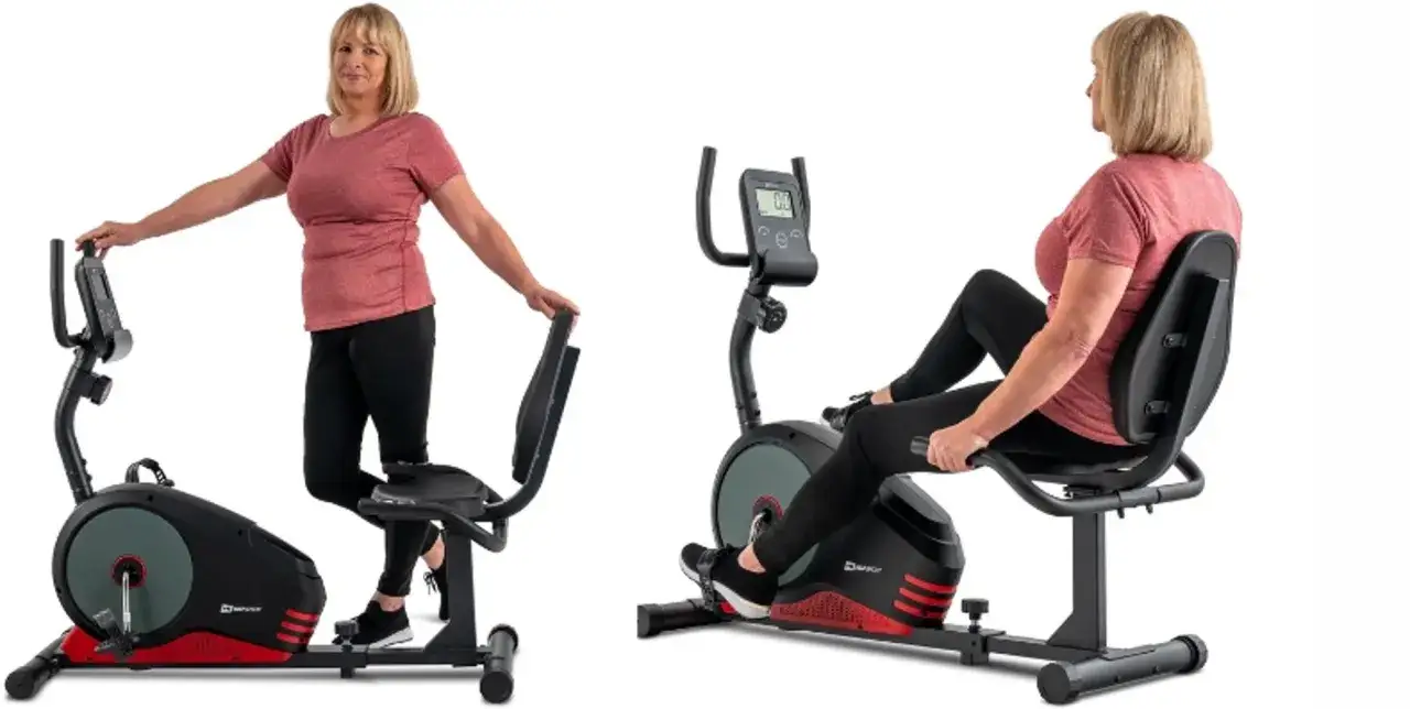 Kobieta obok i na rowerze stacjonarnym. Zastanawiasz się, jaki rower stacjonarny kupić? Ten model jest wygodny.